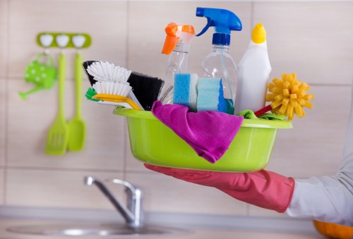 A cleaning professional sanitising a busy commercial workspace