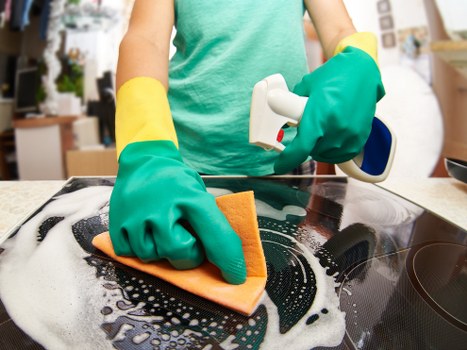 Vacuuming and deep cleaning a fabric sofa in a home setting